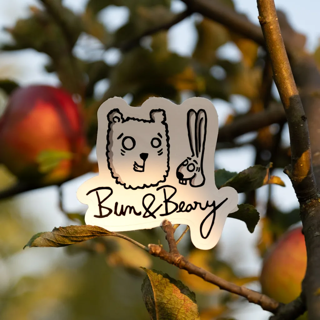 Bun and Beary sign in an apple tree.