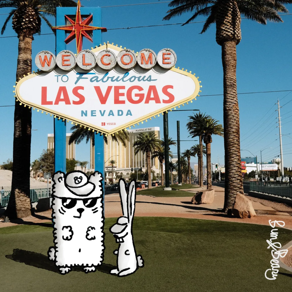 Beary & Bun in front of the Welcome to Fabulous Las Vegas sign.