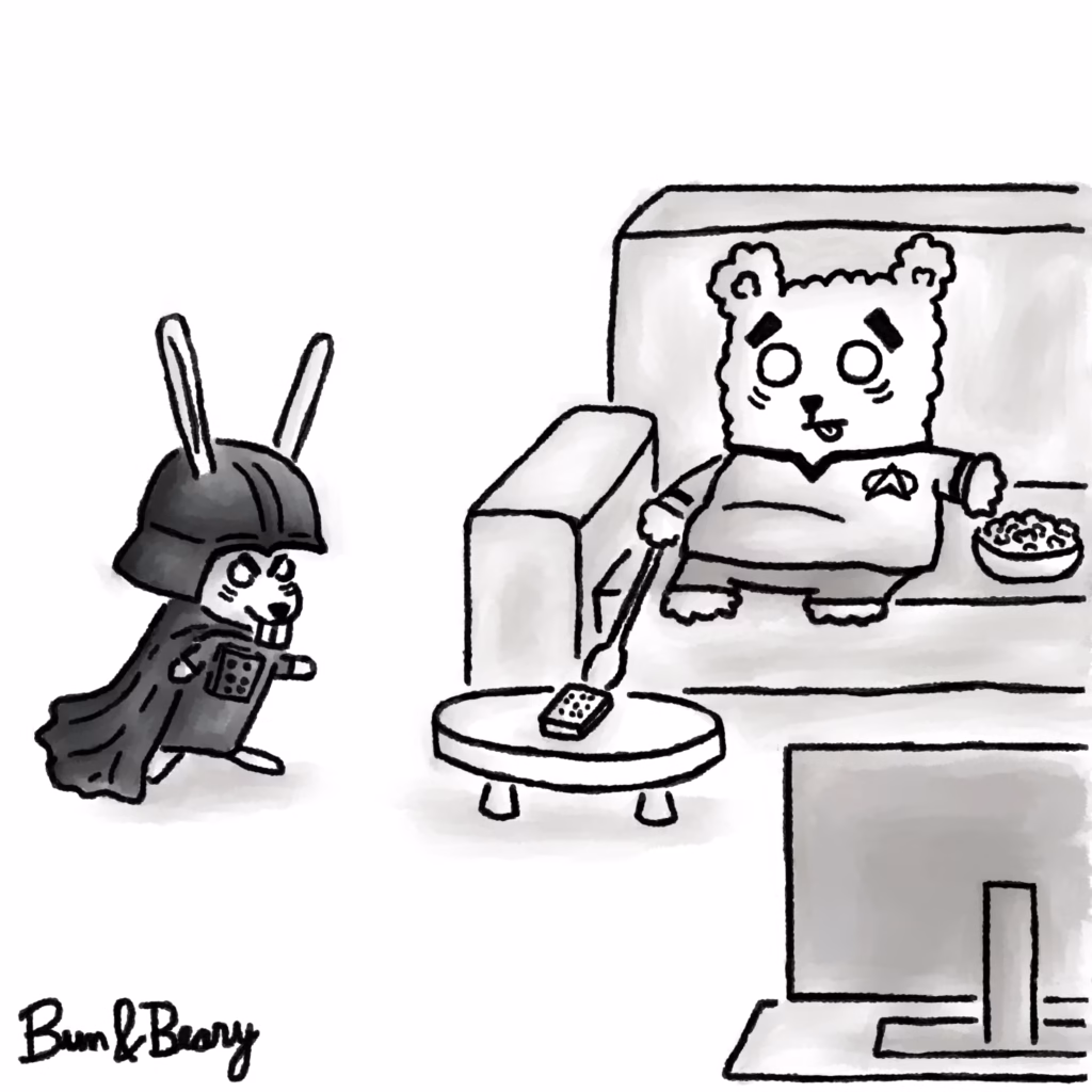 Black-and-white Bun&Beary comic. Bun, dressed in a dramatic Darth Vader-style costume, tries to reach a TV remote on a coffee table. Beary sits calmly on the sofa in a Star Trek-style uniform, using a long spoon to get the remote first. A bowl of snacks sits beside him.