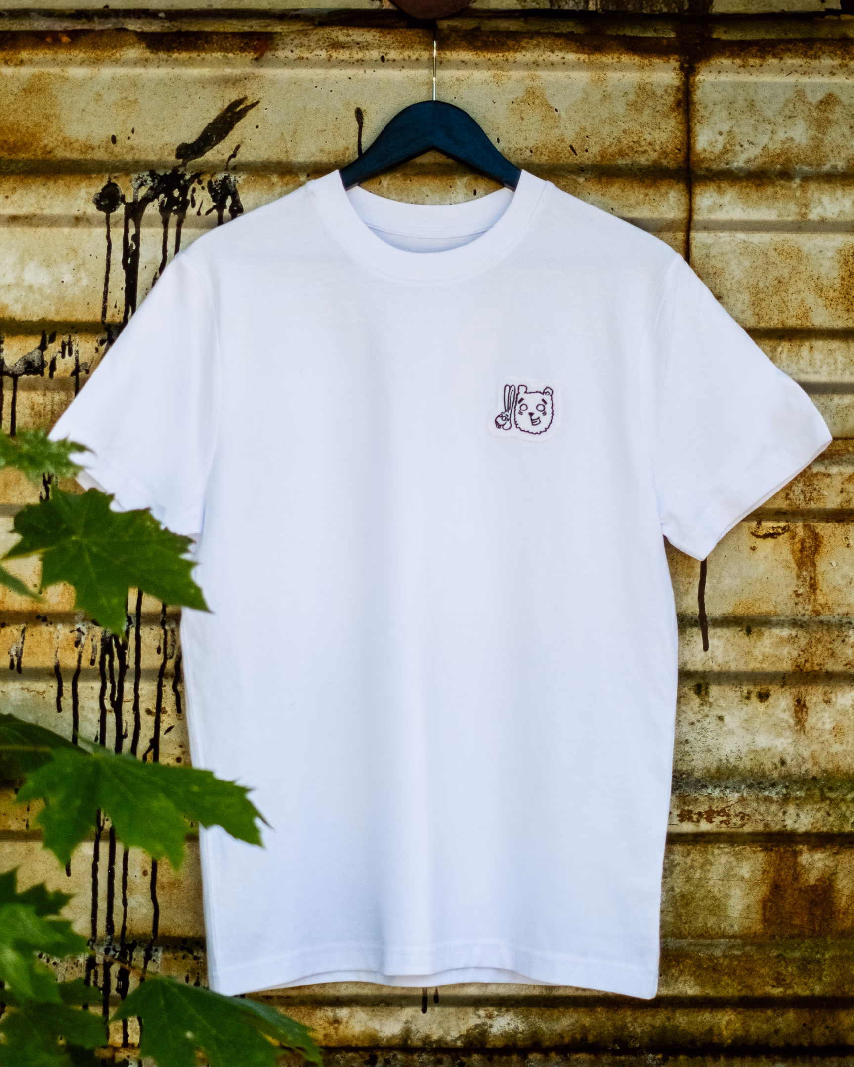 Front of the Side by Side white T-shirt with a small Bun and Beary chest patch